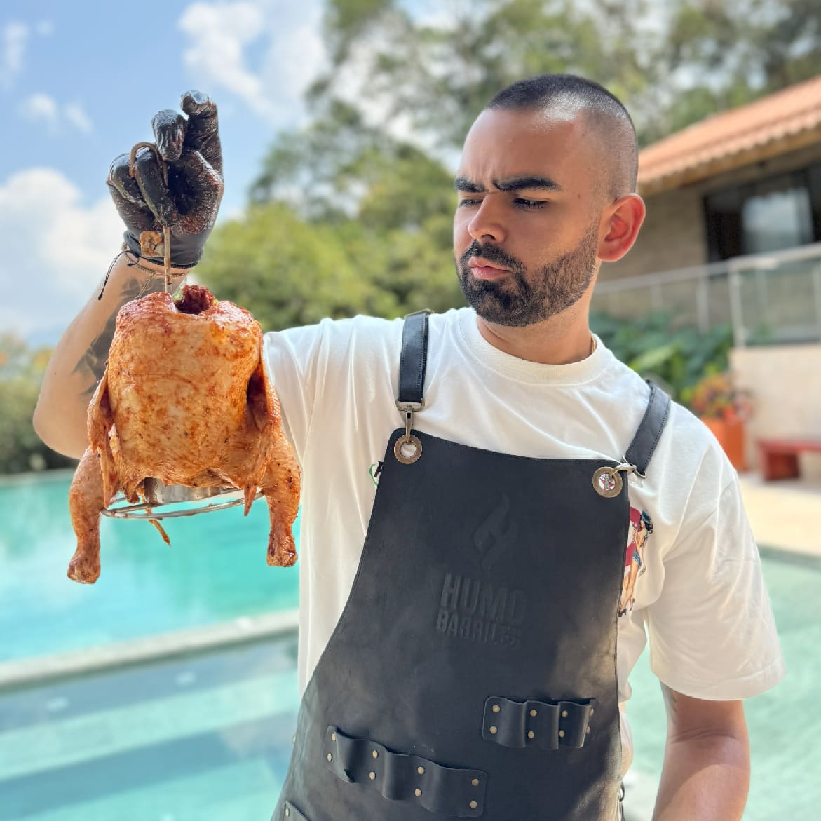 ACCESORIO PARA POLLO 
Pollo adobado y sentado en accesorio sostenido por Andres Barriles